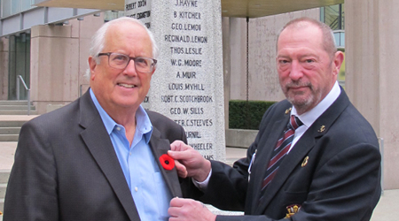 Mayor Malcolm Brodie receives this year’s first poppy from Matthew McBride, Chair of the Richmond Remembrance Day Committee