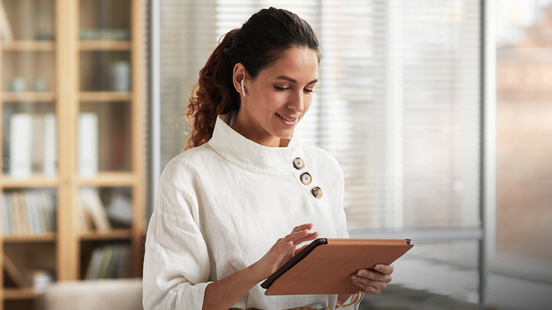 Woman business owner looking at a tablet device