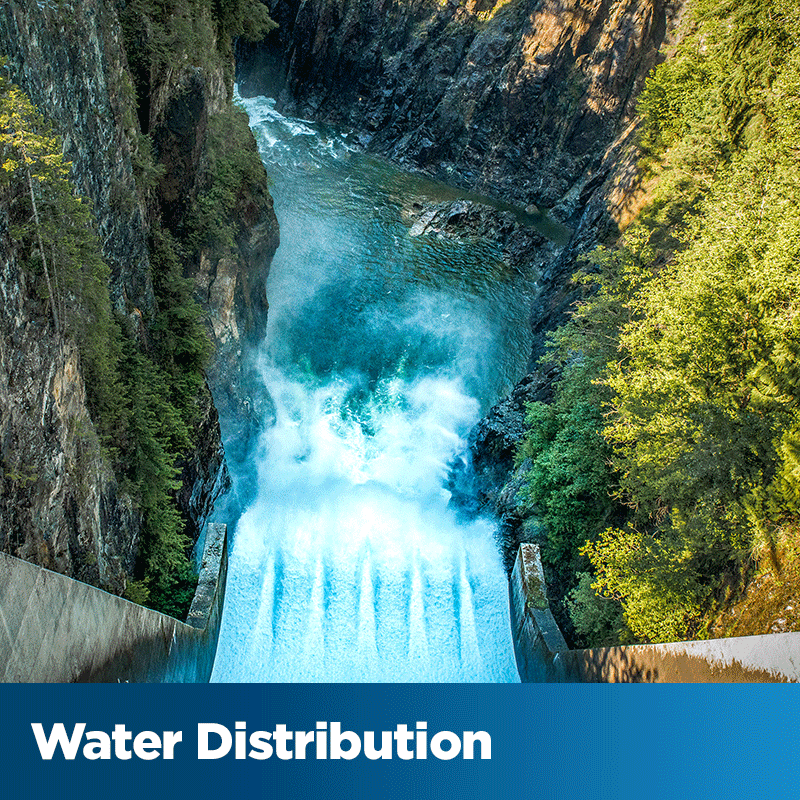 Water Distribution - water rushing from a dam structure into a rocky canyon 