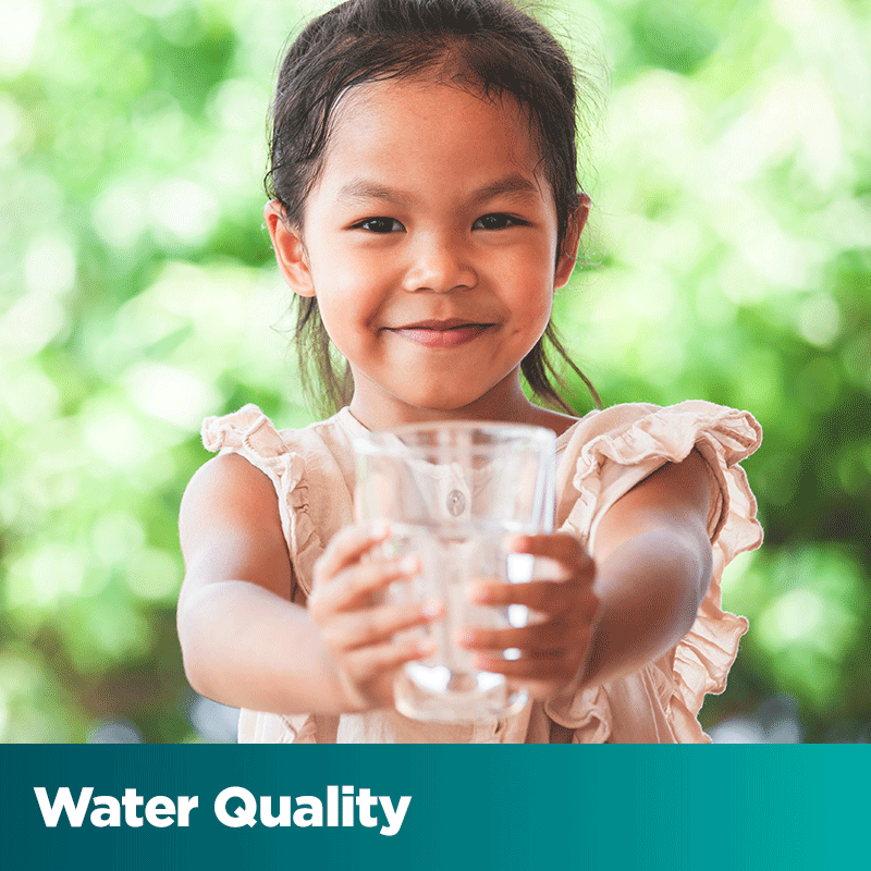 Water Quality - smiling girl holding a glass of water