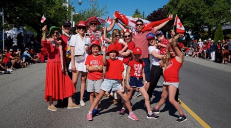 Group of people wearing red and white and celebrating Canada Day