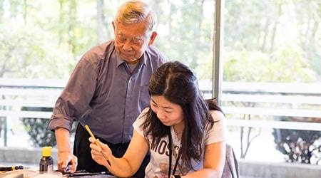 Student and instructor in a calligraphy class