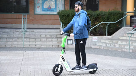 Man riding an electric kick-scooter