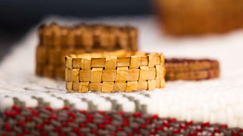 Hands with woven bracelets in a circle