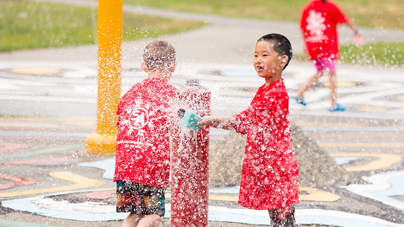 Kids playing in a spray park on a hot summer day