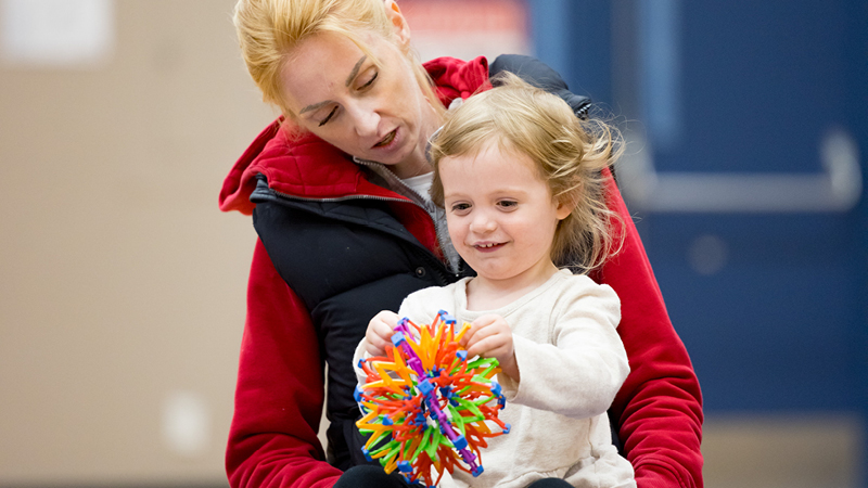 A parent and child taking a program together