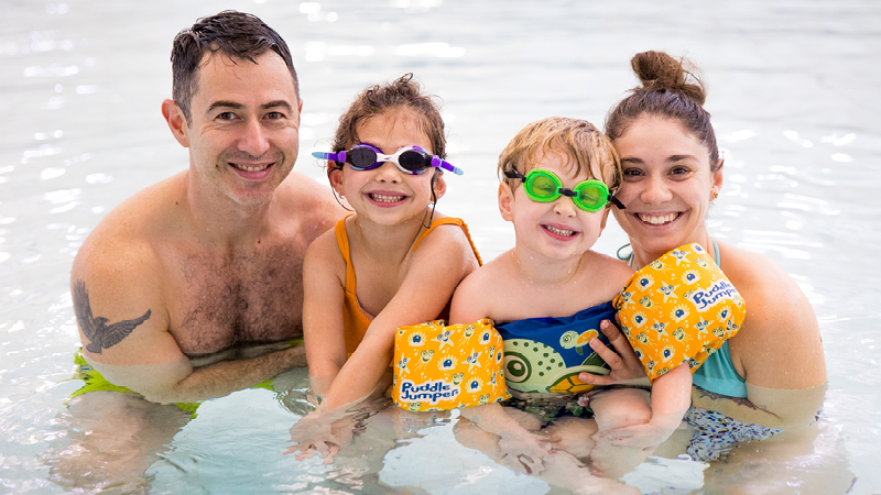 A family swimming in a pool