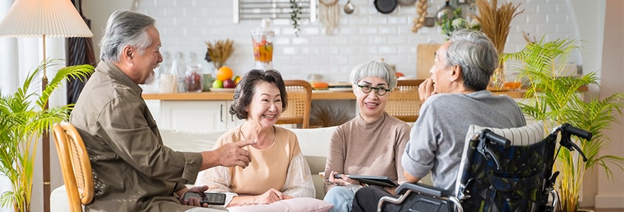 Group of seniors sitting in a living room, enjoying talking together