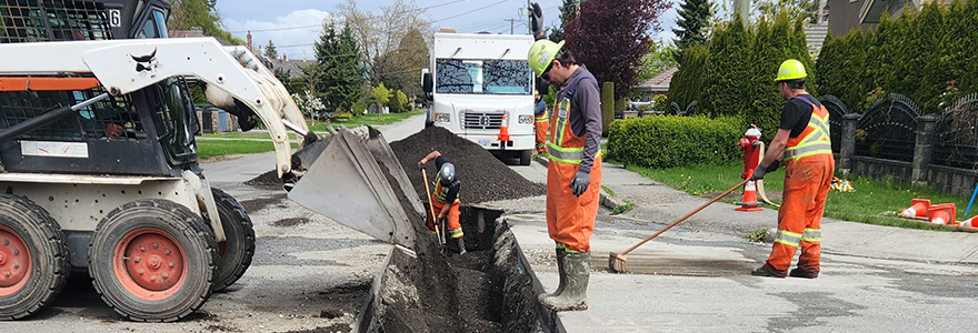 City workers working in an excavated trench