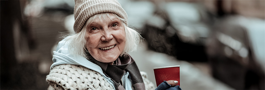 Smiling woman holding a hot beverage