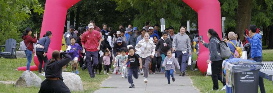 View of children running under an arch at a community event