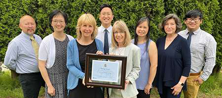 A photo of the teachers at Cornerstone Christian Academy with their Heritage Award