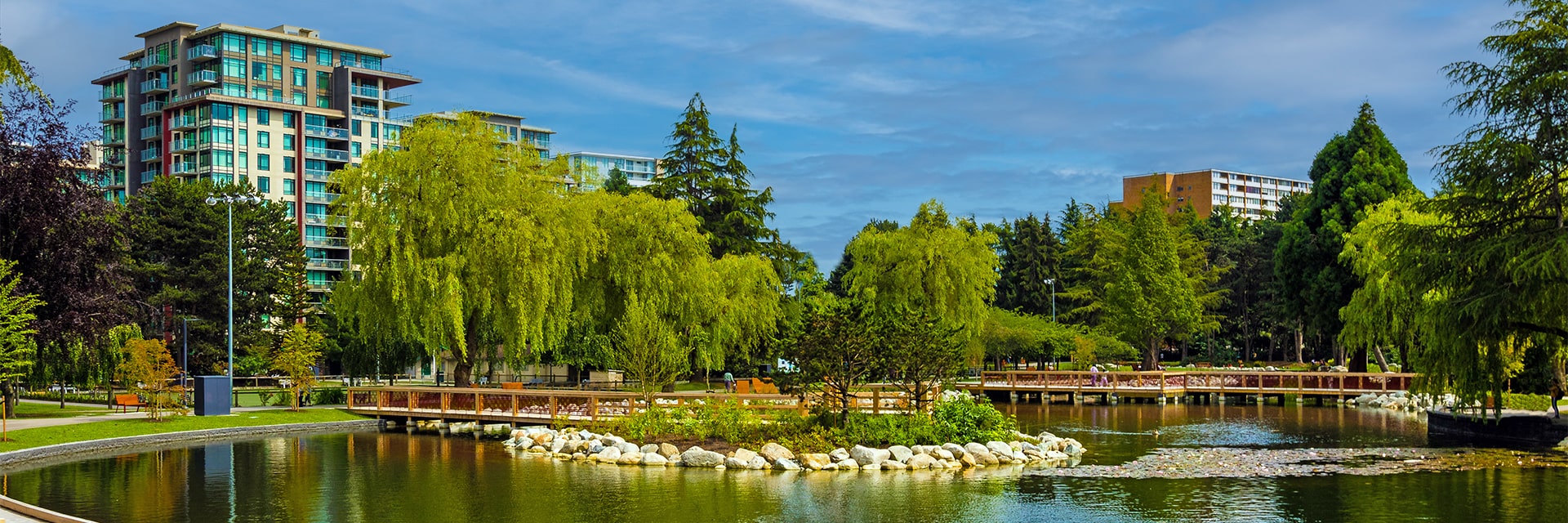 View of the lakes, paths, bridges and trees in the Minoru Lakes District.
