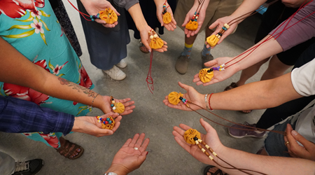 Hands showing Indigenous bracelet crafts