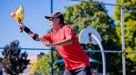 View of a man playing pickleball