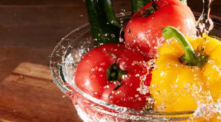 Bowl of vegetables being splashed with water