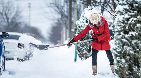 Woman shoveling snow