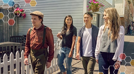 Three people walking though Steveston village