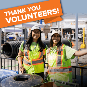Two female green ambassador volunteers in high visibility vests