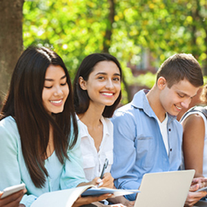 Three young people sitting together doing homework