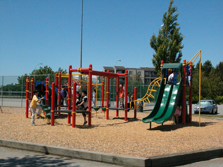 Burnett/Thompson Park - north facing view of west playground. Tennis courts and lacrosse box in background.