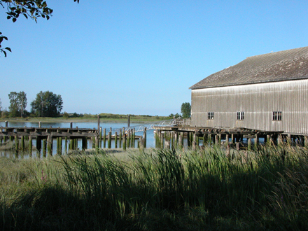 View of Britannia shipyard building on west side of park, facing south from the boardwalk