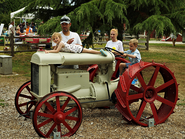 London Farm - family posing with tractor